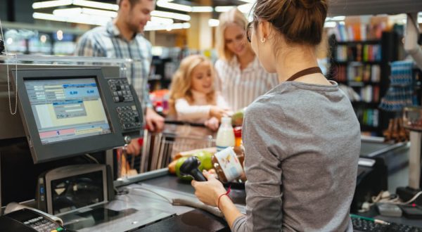 beautiful-family-standing-cash-counter