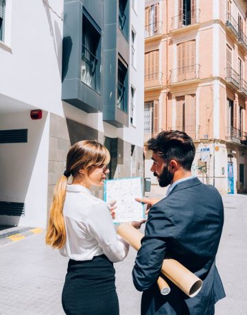 real-estate-agents-talking-about-documents_23-2147650191